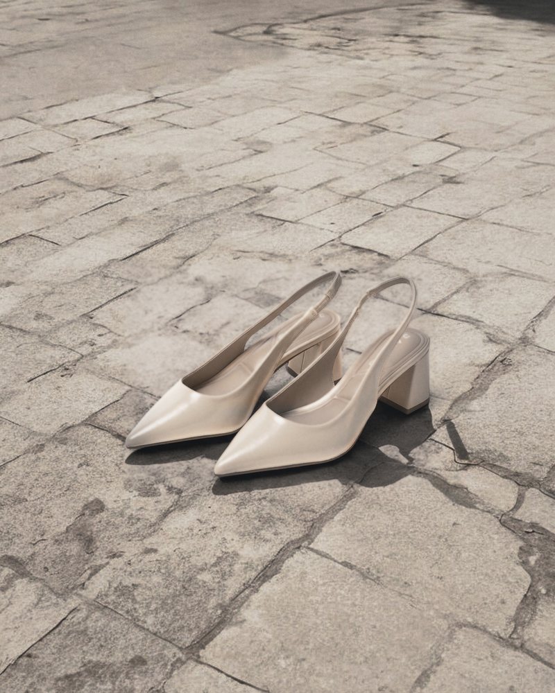 Beige J.Adams Simone pointed slingback block heels set on sunlit stone paving